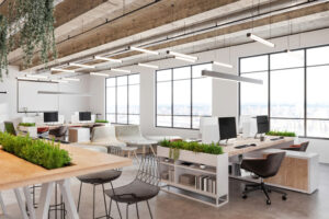 Modern open plan office space interior. Large table, stools, desks, armchairs, computers, concrete floor, pendant lamps, large windows. Template for copy space. Render.